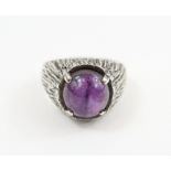 A 1970s silver cabochon amethyst set ring, finger