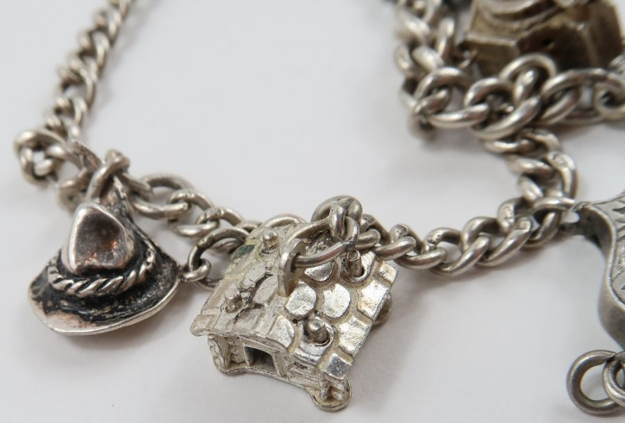 A silver curb link bracelet, with various charms a - Image 5 of 10