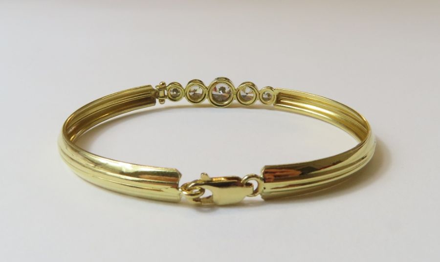 An oval bangle set with five graduated cubic zirco - Image 2 of 3