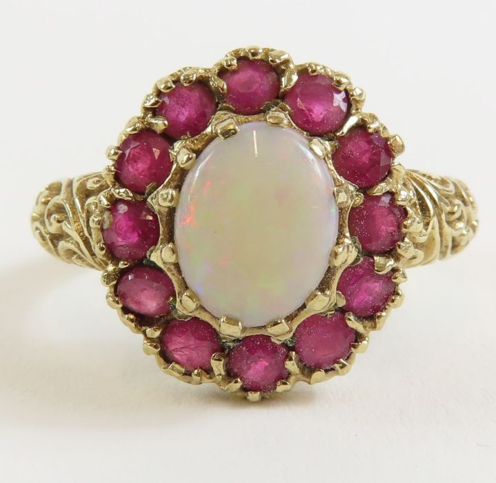 A 9ct gold opal and ruby cluster ring, the oval op