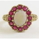 A 9ct gold opal and ruby cluster ring, the oval op