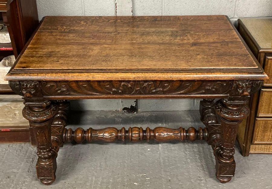 ## WITHDRAWN ## A Victorian carved dark oak side table, with singl