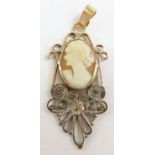 A brown shell cameo in an unusual decorative mount