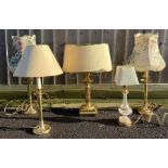 A pair of modern brass lamps, along with three oth
