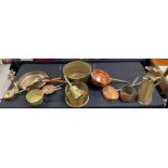 A collection of copper kitchen items including sauc