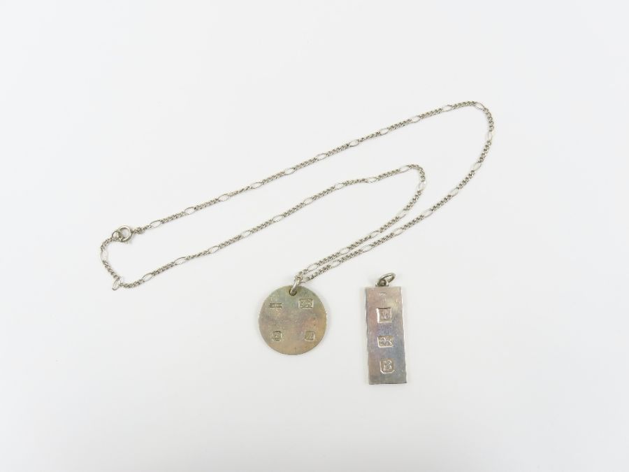 A silver feature hallmark ingot pendant on a chain