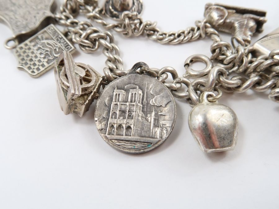 A silver curb link bracelet, with various charms a - Image 9 of 10