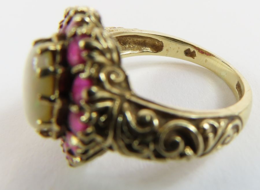 A 9ct gold opal and ruby cluster ring, the oval op - Image 6 of 9