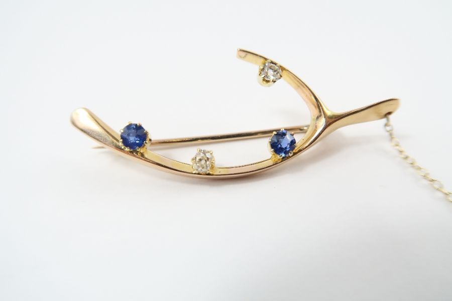 A sapphire and diamond 'now make a wish' wishbone