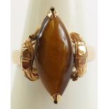 A tiger's eye stone set ring, the single cabochon