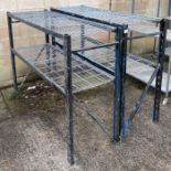 A near pair of industrial metal shelving units