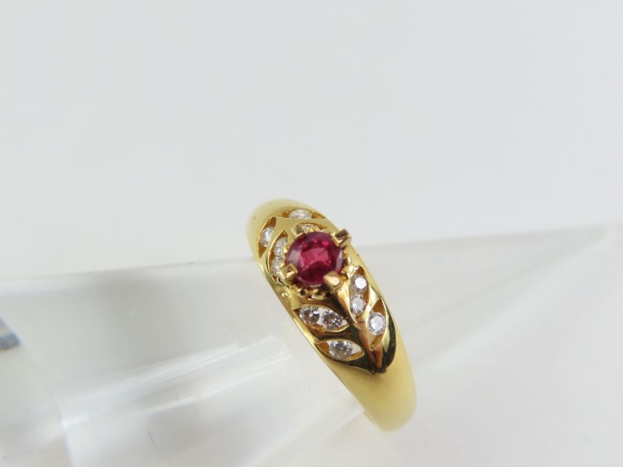 A ruby and diamond dress ring, the round ruby appr