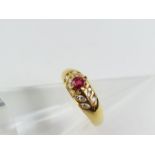 A ruby and diamond dress ring, the round ruby appr