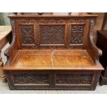 A Victorian oak carved bench, with lift up lid sec