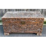 A 20th century camphor wood blanket box, carved
