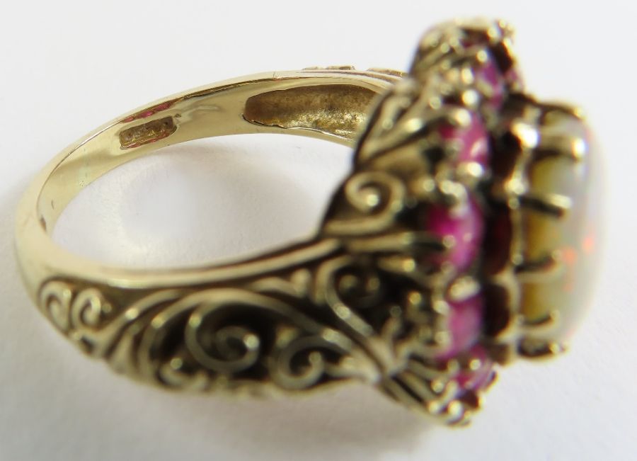A 9ct gold opal and ruby cluster ring, the oval op - Image 7 of 9