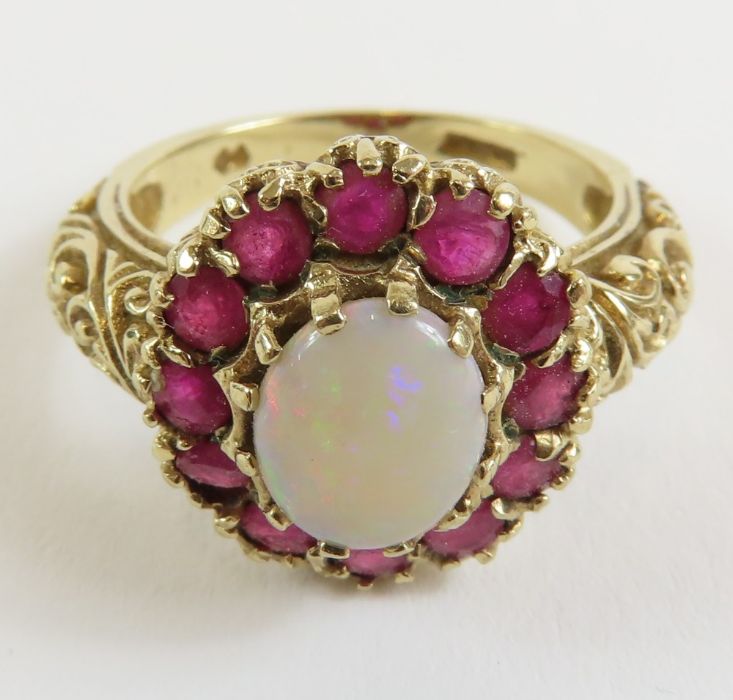 A 9ct gold opal and ruby cluster ring, the oval op - Image 2 of 9