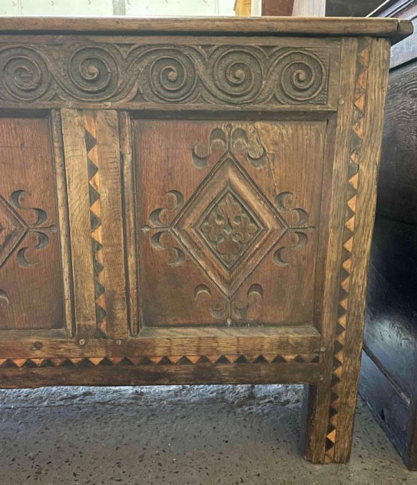 An 18th century carved oak coffer, the three front - Image 5 of 5