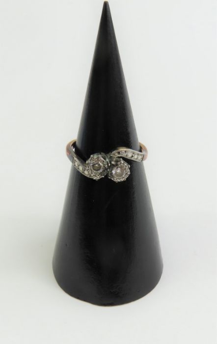 A diamond two stone twist ring, marked '18ct plat'
