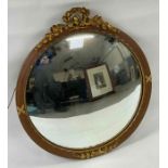 A 20th century convex wall mirror, in a reeded gil