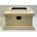 A 20th century bone casket, with brick panels thro