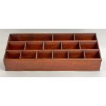 A stained wood stationery rack 66vms wide 22.5cms