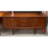 A mid century teak sideboard, set with three short