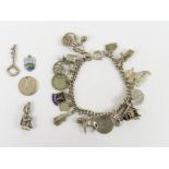 A curb bracelet with various charms attached, char