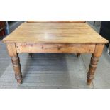 An early 20th century pine table with a single dra