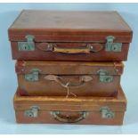 Three vintage leather travelling suitcases