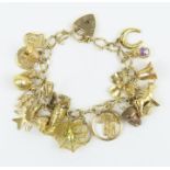 A 9ct gold charm bracelet with heart padlock, and