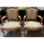 A pair of 20th century open armchairs, each with a