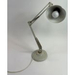 A vintage white painted metal adjustable desk lamp