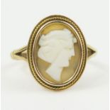 A brown shell cameo ring, marked '9ct', finger si