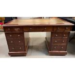 A 20th century mahogany twin pedestal desk, with a