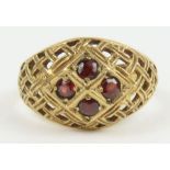 A garnet set dress ring with cut out weave head, m