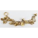 A 9ct gold fancy link bracelet with various charms