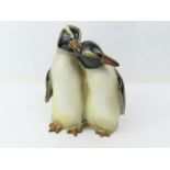 A Royal Doulton figure of two penguins, painted ma