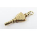 An unusual gold pocket watch key, with floral deco