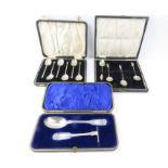 A cased silver spoon and pusher set, a cased silve