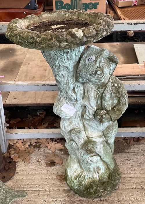 A stone effect bird bath on support moulded with f