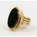 An unmarked ring set with a large oval black onyx,
