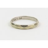 A 9ct white gold wedding band with facetted decora