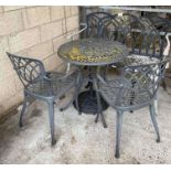 A painted metal circular table with pair of chairs