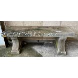 A stone effect garden bench seat with shaped suppo