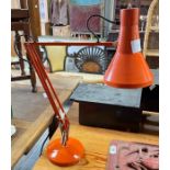 An orange anglepoise lamp