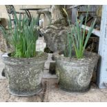 A pair of stone effect planters with moulded Tudor