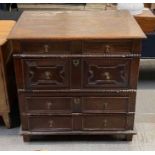 An oak two section travelling chest of four long drawers with applied mouldings