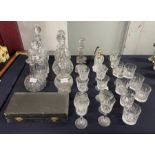 Six assorted clear glass decanters; pair of glass