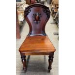 A Victorian mahogany hall chair the back with cent